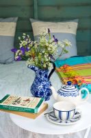 Tea cup and books on side table 