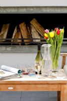 Drinks and flowers on wooden table 