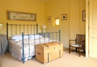 Country bedroom with iron bedstead 