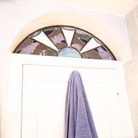 Detail of stained glass window over door 