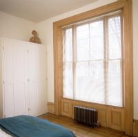 Large window in classic bedroom 