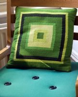 Green patterned cushion on blue chair 