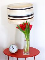 Vase of red tulips on bedside table 