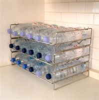 Bottles of water stacked on wine rack 