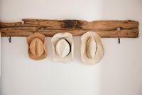 Hats hanging on driftwood shelf