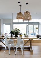Wooden trestle table in contemporary open plan dining room