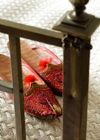 Embroidered Moroccan slippers on bed