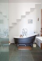 Roll top bath in alcove under stairs