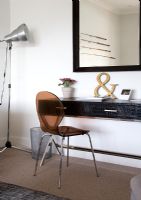 Black leather console table and perspex chair