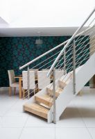 Curved stair case and modern dining room