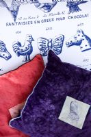 Velvet cushions on armchair in Rococo Chocolates fabric 