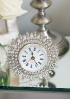 Embellished clock on bedside table