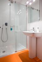Modern shower room with orange floor