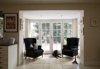 Black armchairs in country style kitchen