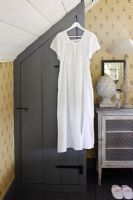 Dress hanging on wooden cupboard