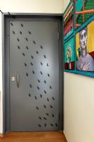 Grey door with plastic ants
