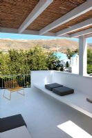 White roof terrace with view of Paros