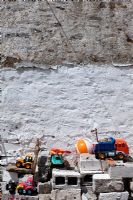 Toys in front of a cement wall 
