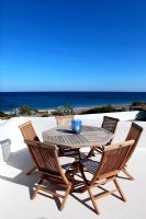 Wooden furniture on terrace with sea view