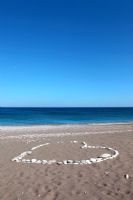 Sandy beach with pebble decoration, Greece