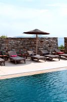 Loungers by swimming pool 