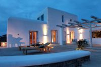 Greek villa and patio lit up at night