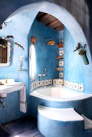 Blue bathroom with corner bath