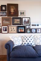 Blue sofa and display of family photos