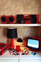 Colourful retro appliances on living room shelves