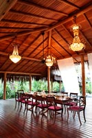 Wooden dining table set for meal on veranda