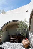 Traditional patio with dining area under arch