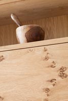 Wooden pestle and mortar on modern kitchen unit