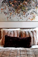 Contemporary bed with faux fur cushions