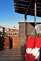 Modern roof terrace with red swing seat