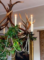 Antler chandelier decorated for Christmas