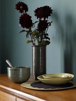 Maroon Dahlias and rustic pottery