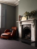 Leather furniture by classic fireplace