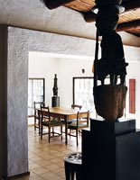 Dining room with tribal sculptures