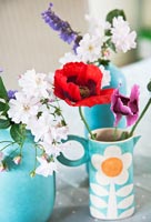 Flowers in turquoise jugs