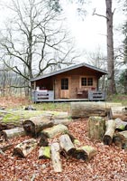 Wooden cabin in woodland garden