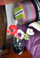 Colourful flowers next to bed