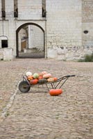 Barrow full of pumpkins in front of Chateau du Rivau, France