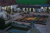 Potager and Golden Fleet Barn lit up at night - Chateau du Riveau