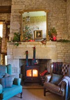 Cotswold stone fireplace decorated for Christmas
