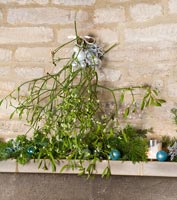 Cotswold stone mantlepiece decorated with Mistletoe