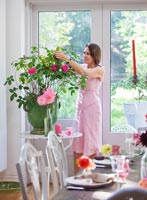 Jacky Hobbs arranging flowers in her dining room