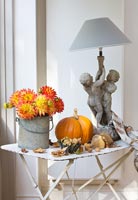 Autumnal display on white metal table with Dahlias
