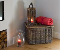 Wooden and glass storm lanterns and wicker storage basket