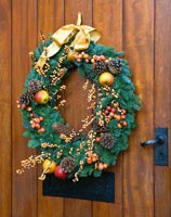 Christmas wreath with berries, fruit and fir cones