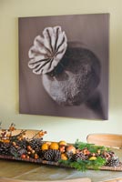 Christmas arrangement of Fir cones, fruit and berries on wooden table with sepia tone photo